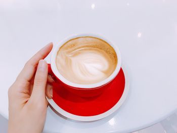 Close-up of hand holding coffee cup