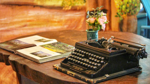 Typewriter and book on table