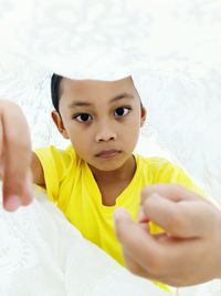 Portrait of boy under textile