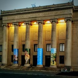 Woman in front of building at night