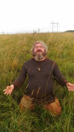 Portrait of man on field against sky