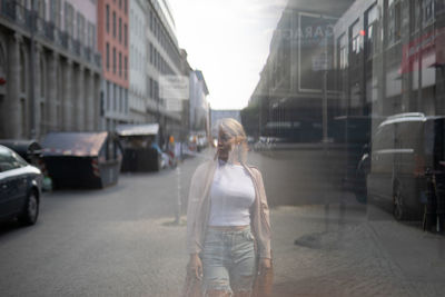 Multiple image of woman walking on road in city
