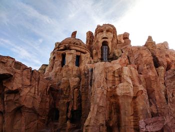 Low angle view of rock formation against sky