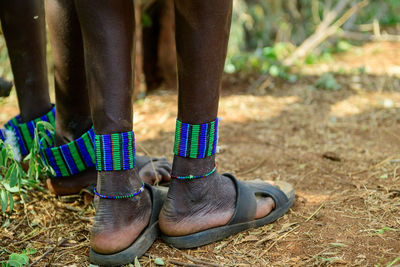 Low section of man standing on field