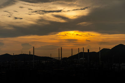 Silhouette buildings against sky during sunset