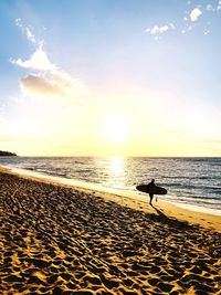 Scenic view of beach against sky during sunset