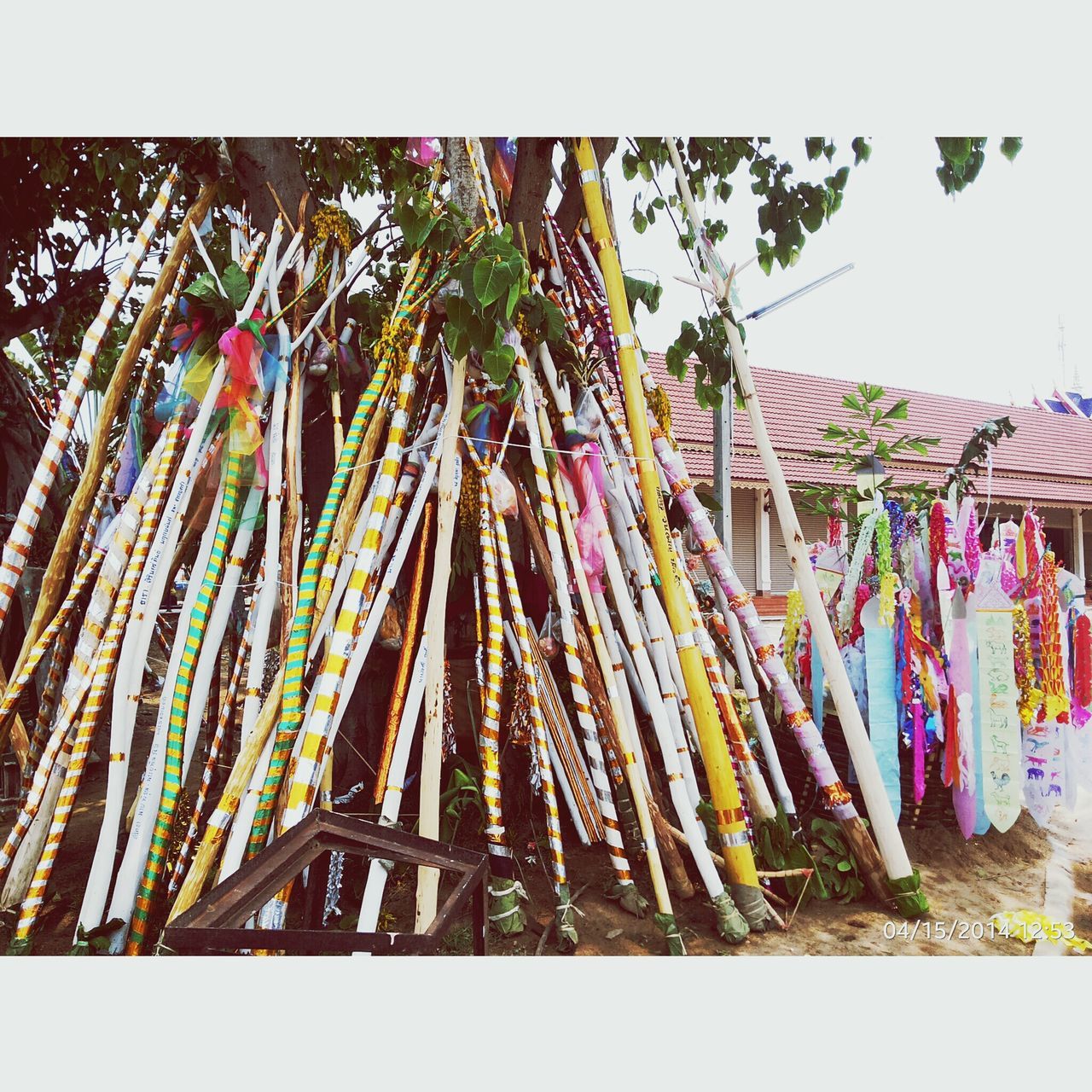 transfer print, auto post production filter, multi colored, low angle view, hanging, built structure, variation, building exterior, decoration, architecture, large group of objects, abundance, growth, no people, day, colorful, outdoors, clear sky, in a row, palm tree