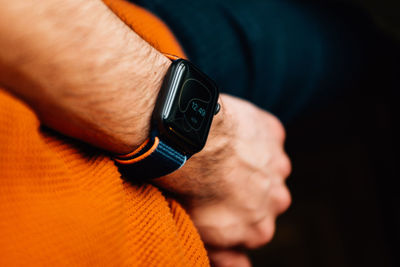 Cropped hand of man holding navigational compass