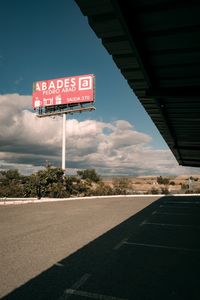 Road sign against sky