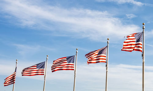 Low angle view of flags flag against sky