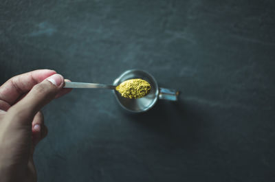 Close-up of hand holding spoon