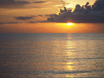 Scenic view of sea against orange sky