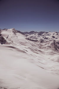 Scenic view of snowcapped mountains against clear sky