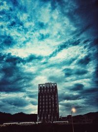 Low angle view of building against cloudy sky