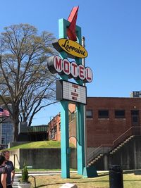 Low angle view of road sign against blue sky