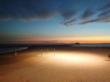 Scenic view of beach against sky during sunset