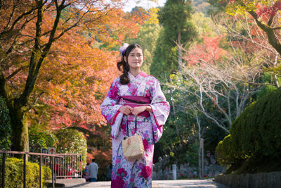 Young woman standing in park