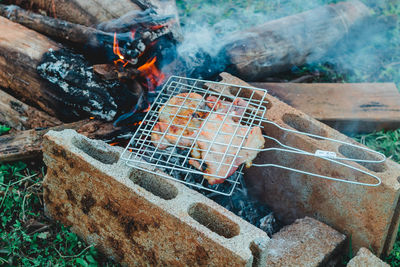 High angle view of meat on barbecue grill