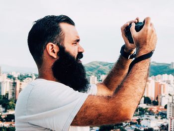 Side view of man photographing