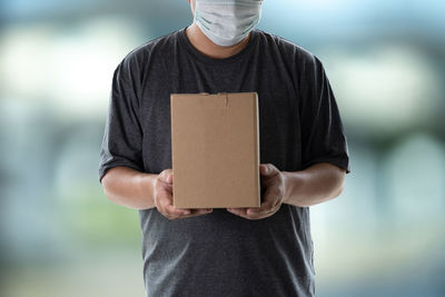 Midsection of man standing on paper