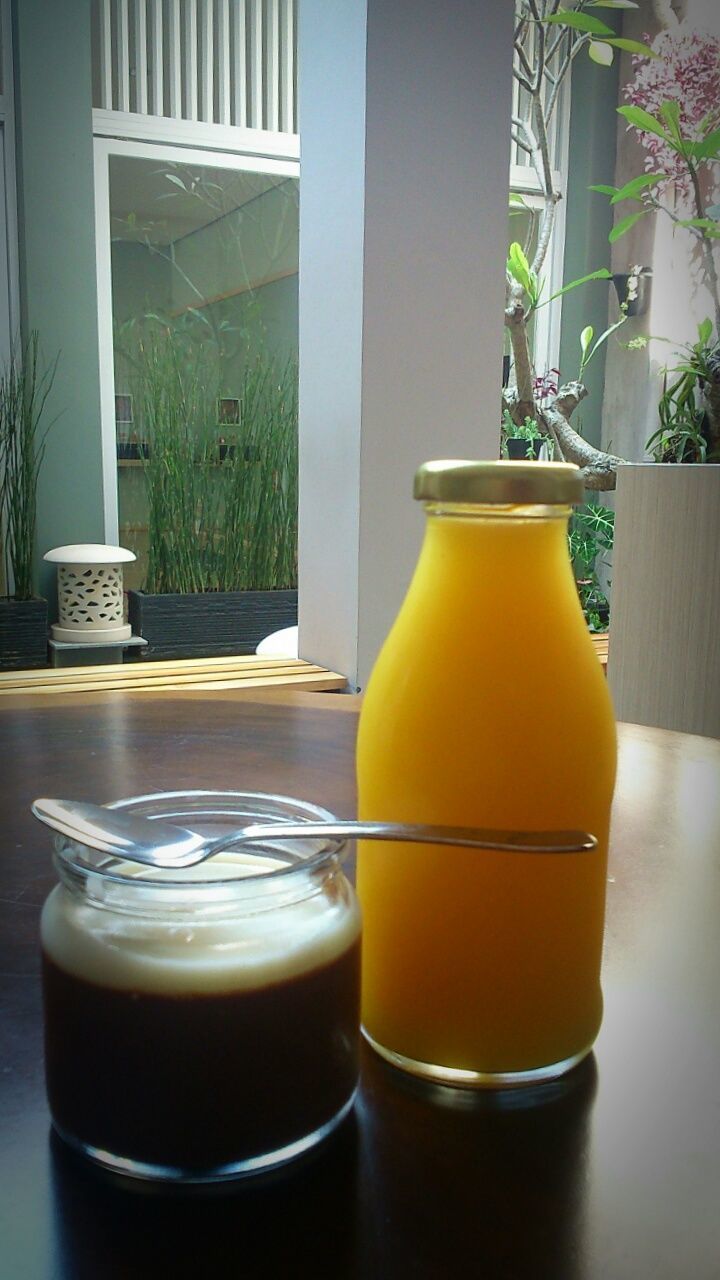 drink, refreshment, yellow, food and drink, indoors, table, window, close-up, architecture, freshness, glass - material, built structure, still life, potted plant, no people, coffee cup, glass, drinking glass, house, day