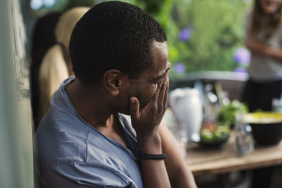 Portrait of young man sitting outdoors