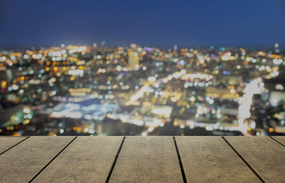 High angle view of illuminated buildings against sky at night