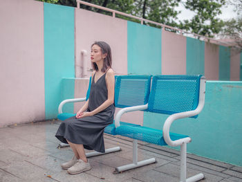 Full length of woman sitting on chair