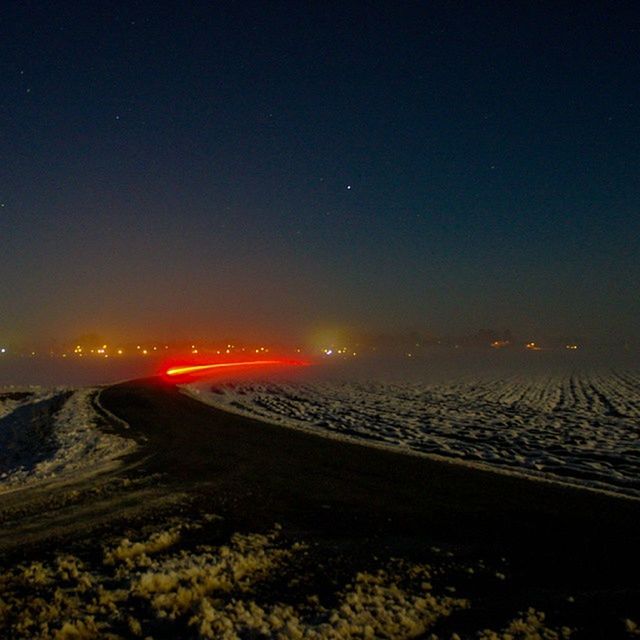 scenics, tranquil scene, night, illuminated, tranquility, landscape, beauty in nature, nature, sky, sunset, mountain, idyllic, copy space, clear sky, snow, winter, transportation, non-urban scene, road, outdoors