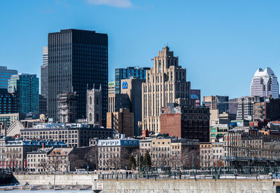 Buildings in city against clear sky