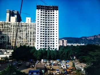 Buildings in city against blue sky