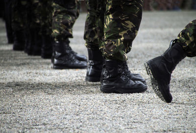 Soliders at a military parade in boots and camouflage clothing