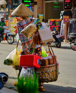 Rear view of vendor walking on street