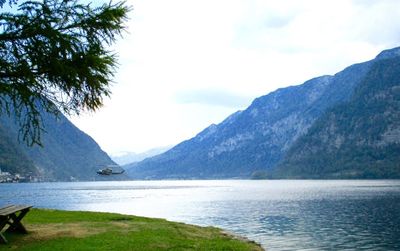 Scenic view of sea and mountains against sky