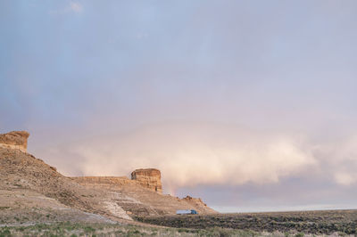 Rock formations on landscape against sky