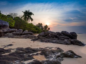 Scenic view of beach against sky during sunset