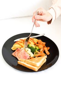 Close-up of man holding food in plate