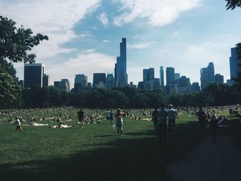 People in park with city in background