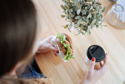 High angle view of woman holding food at home