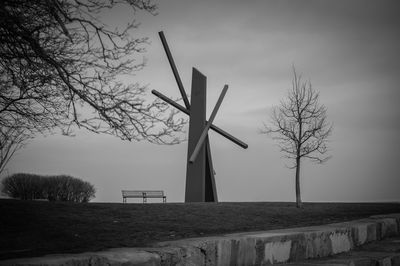 Traditional windmill on field against sky