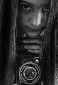 Close-up portrait of woman with camera