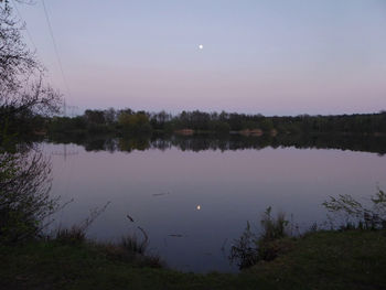 Scenic view of lake against sky at sunset