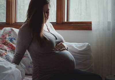 Pregnant woman sitting at home