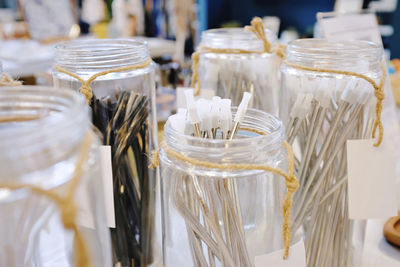 Close-up of knitting needles in jars