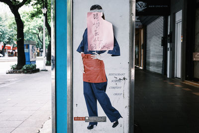 Rear view of man walking on footpath
