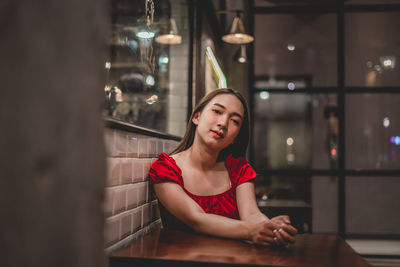 Portrait of young woman sitting at restaurant