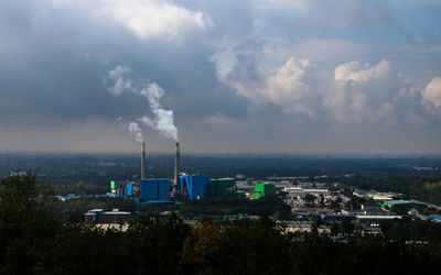 Smoke emitting from power station against sky