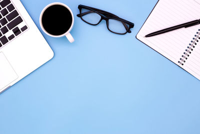 Coffee cup and book on table