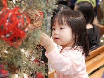 Girl looking at christmas tree