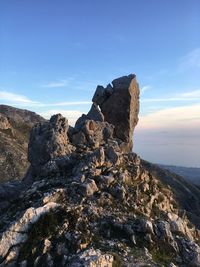 Rock formation on mountain against sky